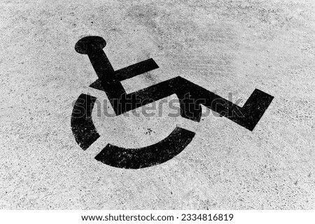 Handicapped sign on the asphalt. Black and white.