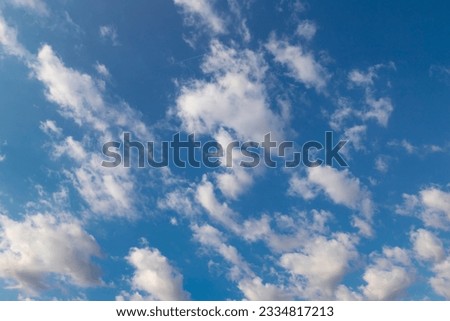 Blue sky with a few clouds background. Beautiful natural background.