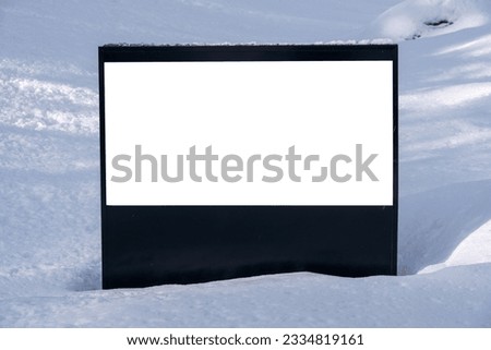 White horizontal billboard in the snow. Blank sign mockup.