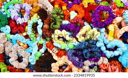 Mix of colorful fabric scrunchies with elastic hairbands.