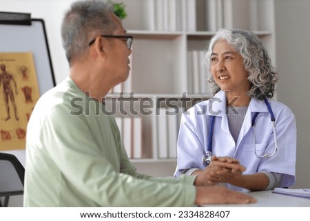 Senior health care concept. Doctor with patient in medical office. Retired man sits in a hospital examination room while discussing his health with a doctor.