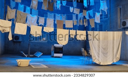 theater scenery on the stage, white bed linen being dried on clothesline, art. High quality photo Royalty-Free Stock Photo #2334829307