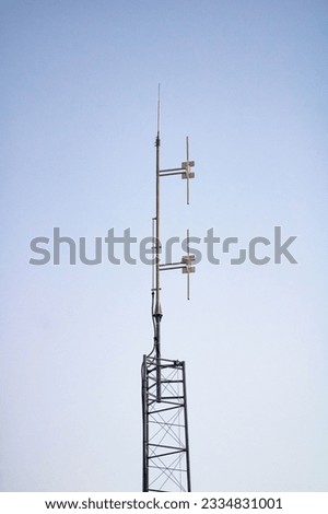 A vertical shot of a telecommunication tower, an antenna of a basic radiotelephone in Ain, France Royalty-Free Stock Photo #2334831001