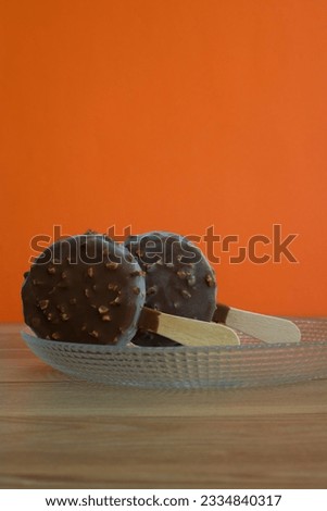 round chocolate ice cream isolated on orange background