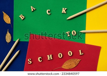 School wooden pencils, leaves of trees and Back to school text. Concept of education, starting school, back to school. Colorful background