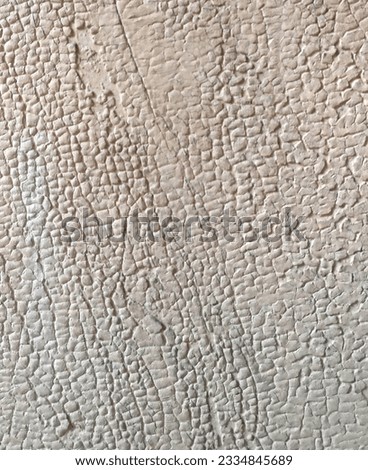 Photo of an abstract background with cracked white beige paint wood. Textural element of the rendering design. Plastered wall in the old town in the Art Nouveau style.