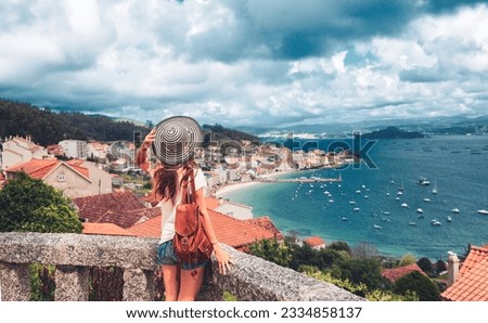 Woman tourist enjoying panoramic view of Raxo village, Pontevedra- Galicia in Spain Royalty-Free Stock Photo #2334858137