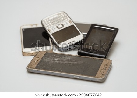 A close-up shot of disposed damaged smartphones