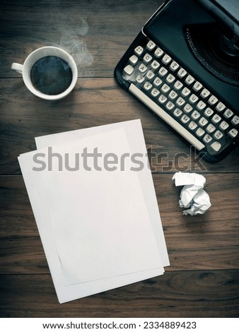 A Vintage Typewriter on a wooden table with coffee and paper. Vintage office space. blank paper