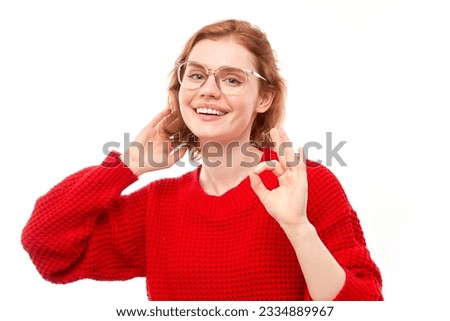 Portrait of young girl showing OK sign with fingers isolated on white background. Successful career, accepted concept