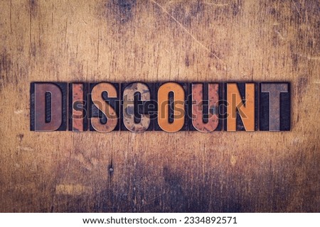 The word -Discount- written in dirty vintage letterpress type on a aged wooden background.