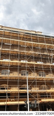 Brick building under construction refurbishment with scaffolding in Central London