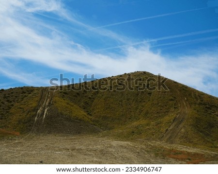 Desert hill with worn path from tires and dirt biking 