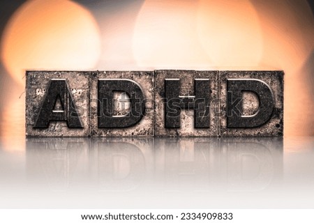 The word -ADHD- written in vintage ink stained letterpress type.