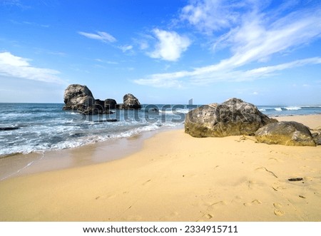 Big stones in the ocean and on a beach of Sri Lanka