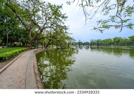 view of The Huc Red Bridge and Ngoc Son temple in the center of Hoan Kiem Lake, Ha Noi, Vietnam. Famous destination of Vietnam Royalty-Free Stock Photo #2334928333