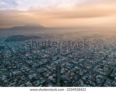 Aerial view of Long Hoa market, a famous market at Tay Ninh city, Vietnam, far away is Ba Den mountain in the morning. Travel and landscape concept Royalty-Free Stock Photo #2334928421