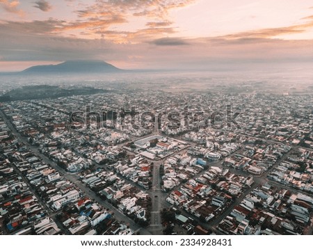 Aerial view of Long Hoa market, a famous market at Tay Ninh city, Vietnam, far away is Ba Den mountain in the morning. Travel and landscape concept Royalty-Free Stock Photo #2334928431