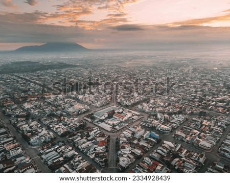 Aerial view of Long Hoa market, a famous market at Tay Ninh city, Vietnam, far away is Ba Den mountain in the morning. Travel and landscape concept Royalty-Free Stock Photo #2334928439
