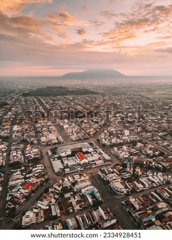 Aerial view of Long Hoa market, a famous market at Tay Ninh city, Vietnam, far away is Ba Den mountain in the morning. Travel and landscape concept Royalty-Free Stock Photo #2334928451