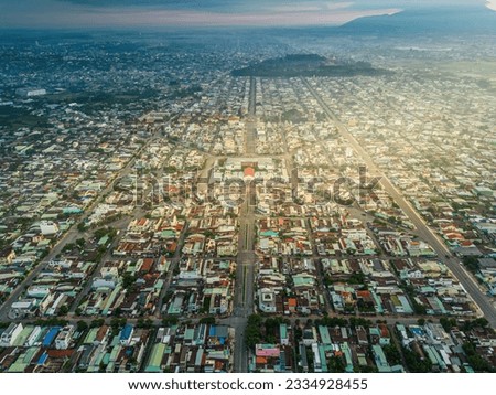 Aerial view of Long Hoa market, a famous market at Tay Ninh city, Vietnam, far away is Ba Den mountain in the morning. Travel and landscape concept Royalty-Free Stock Photo #2334928455
