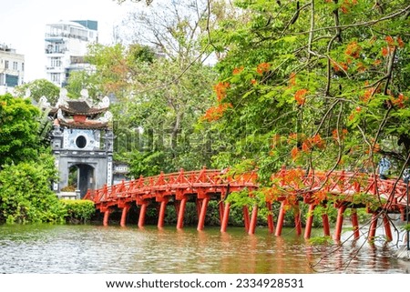 view of The Huc Red Bridge and Ngoc Son temple in the center of Hoan Kiem Lake, Ha Noi, Vietnam. Famous destination of Vietnam Royalty-Free Stock Photo #2334928531