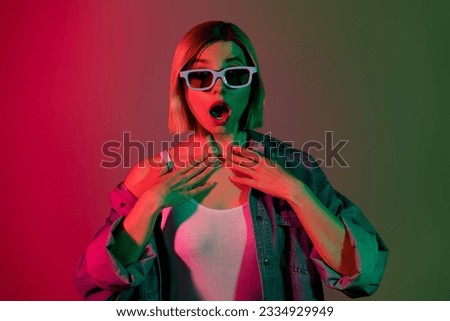 Photo of lady open mouth impressed thriller series watching tv with 3d glasses isolated colorful gradient neon background