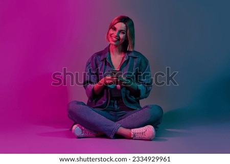 Photo of lady blogger using smart gadget chatting on social network isolated on ultraviolet neon color background