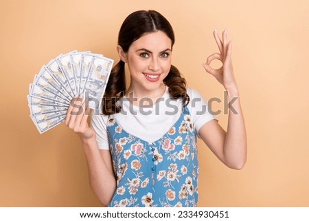 Photo of young rich shopaholic lady spend much money website buy more clothes accessories show okey sign isolated on beige color background