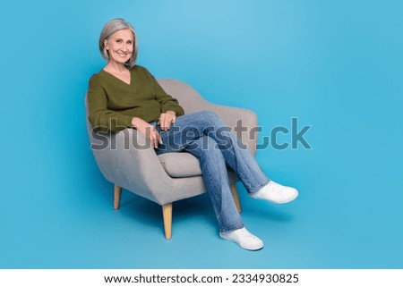 Full body photo of good mood pensioner grey hair woman sitting comfort furniture interview her candidates isolated on blue color background