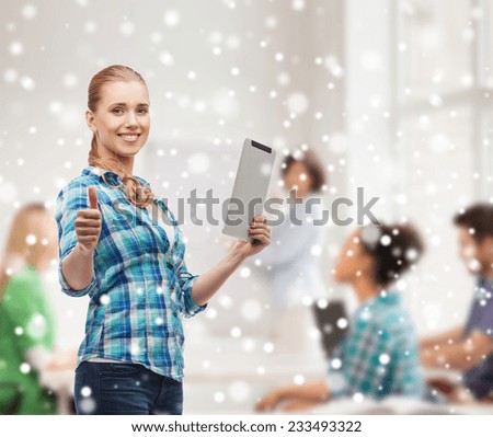 technology, gesture, education, school and people concept - smiling girl with tablet pc computer showing thumbs up over classroom and snow background