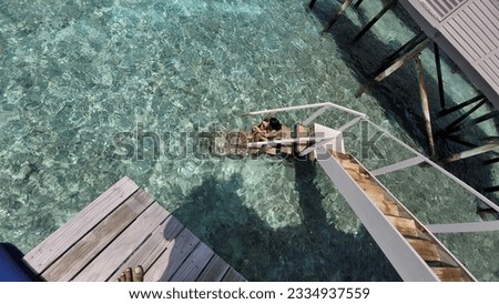 This is a very nice picture of a girl enjoying in water. There are steps in the water villa room which are directly connected to ocean. And its amazing to spend time privately. 