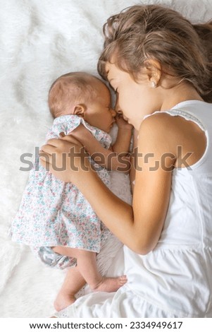 newborn toddler with older sister. selective focus. people.