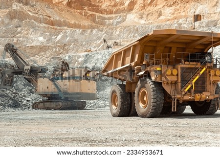 Electric rope shovel and dump truck at a copper mine in Peru Royalty-Free Stock Photo #2334953671