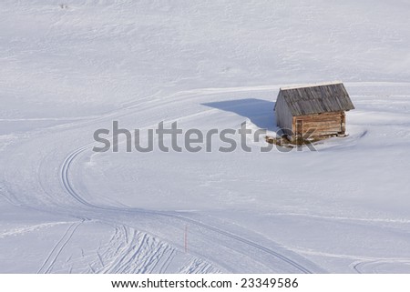 a mountain hut in fresh powder snow