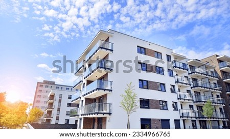 Eco city with modern exterior design of apartment building and landscaping. Garden yard by residential buildings.. Contemporary eco friendly residential architecture. Eco-friendly living in a city. Royalty-Free Stock Photo #2334966765