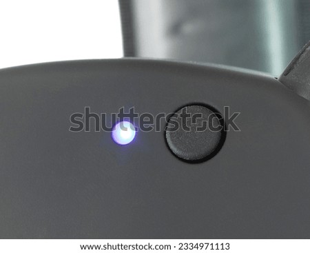 Button to turn on the wireless conncection on electronic hearing protection and LED indicator light