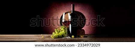 Wine and wooden cask on table and vinous background