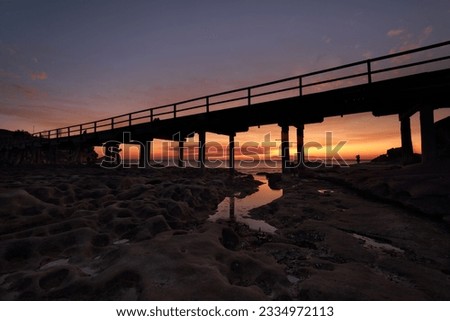 The eroded cratered rocks under the bridge at Bare Island, La Perouse Botany Bay as the sun sets