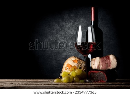 Meat and red wine on a wooden table
