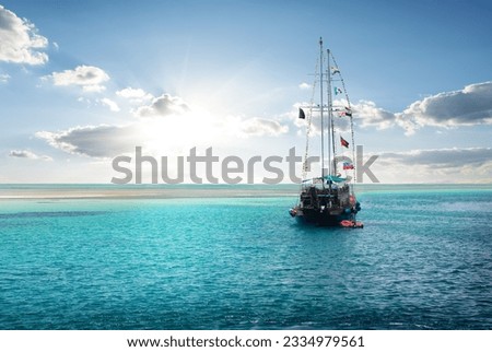 Yacht in the sea near island at sunrise