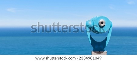 panorama of binoculars and ocean in the background Royalty-Free Stock Photo #2334981049