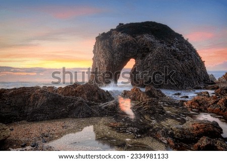 The spirited horse drinks from the wild untamed ocean. Horse Head Rock, Bermagui at sunrise