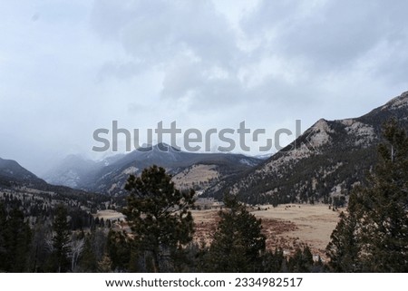 Storm rolling in high country of Colorado.  Trees in the foreground of the Rocky Mountains of Colorado.  High positioned view of mountain valley with trees in the foreground.  Overlook of Sheep Lakes. Royalty-Free Stock Photo #2334982517