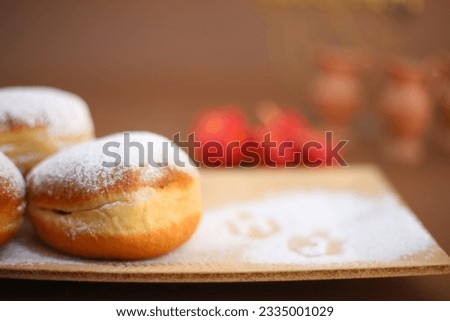 Religion image of jewish holiday Hanukkah background with Donut (traditional food)sufganiyot with powdered sugar and spinning top