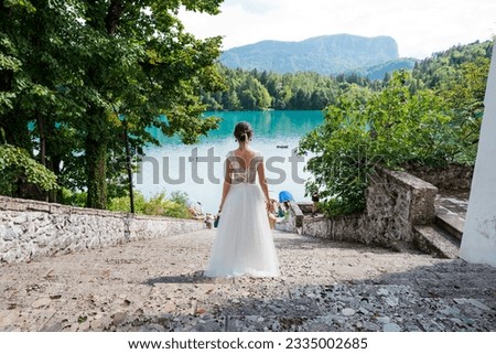 Beautiful bride in white wedding dress at the most beautiful island in Slovenia, Bled.