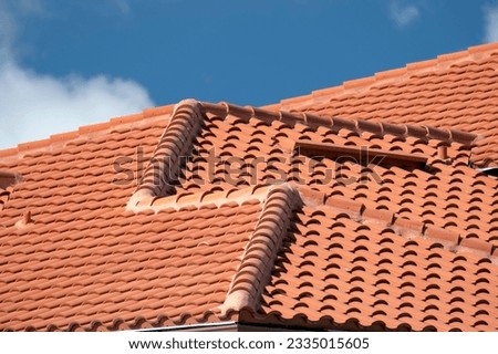 Tiled roof covering of condo building in Florida. Closeup of house rooftop covered with ceramic shingles Royalty-Free Stock Photo #2335015605