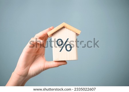 interest percent symbol icons on wooden house cube, home real estate.