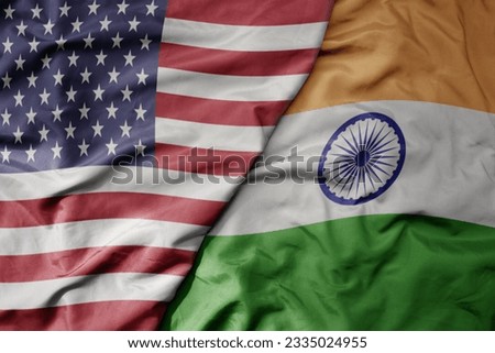 big waving colorful flag of united states of america and national flag of india . macro