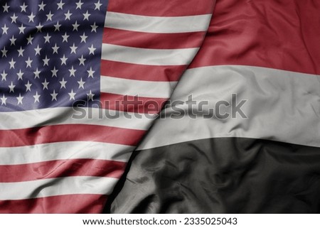 big waving colorful flag of united states of america and national flag of yemen . macro Royalty-Free Stock Photo #2335025043